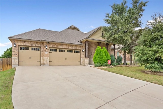 view of front facade with brick siding, concrete driveway, a garage, and roof with shingles