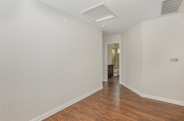 empty room with dark hardwood / wood-style flooring