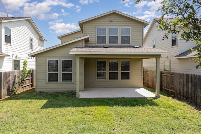 rear view of property with a yard and a patio