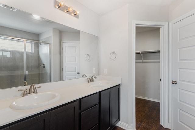 bathroom with vanity, wood-type flooring, and an enclosed shower