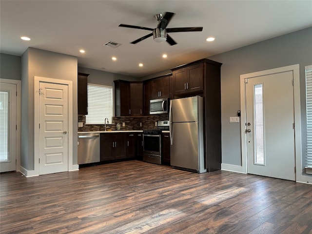 kitchen featuring plenty of natural light, stainless steel appliances, ceiling fan, and dark hardwood / wood-style floors