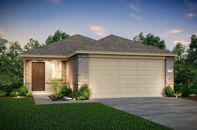 view of front of property with a garage and a lawn