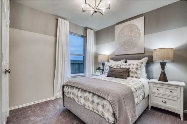 bedroom featuring dark colored carpet and an inviting chandelier