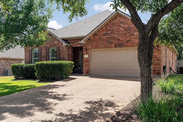 view of front of house with a garage and central AC