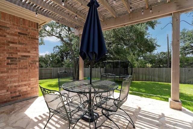 view of patio featuring a pergola and a trampoline