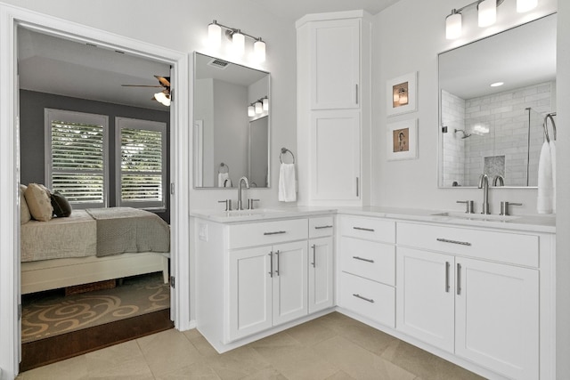 bathroom featuring tile patterned floors, ceiling fan, vanity, and tiled shower