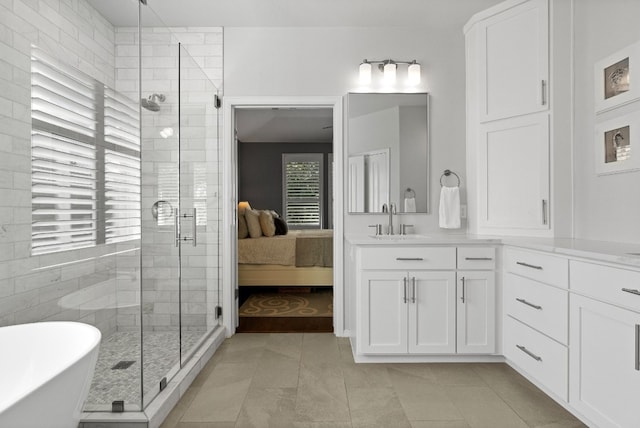 bathroom with tile patterned floors, vanity, and independent shower and bath