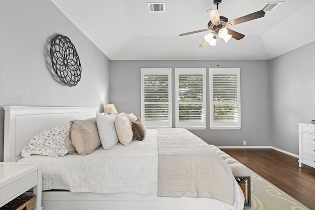 bedroom with ceiling fan, dark hardwood / wood-style flooring, and vaulted ceiling