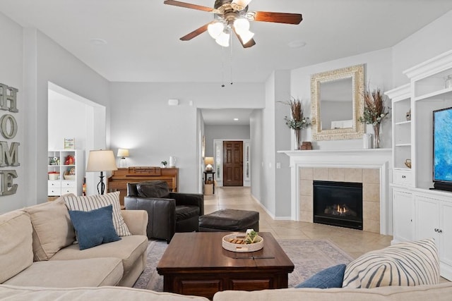 living room with ceiling fan, light tile patterned flooring, and a fireplace