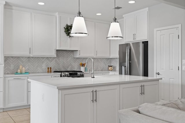 kitchen with decorative backsplash, stainless steel refrigerator with ice dispenser, a kitchen island with sink, decorative light fixtures, and white cabinets