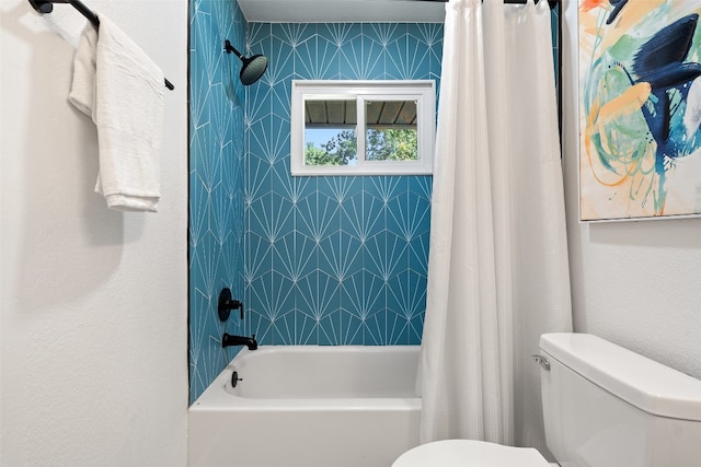 bathroom with shower / bath combo and toilet