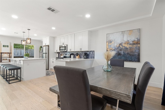 dining area with light hardwood / wood-style floors