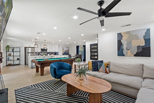 game room featuring ceiling fan, light hardwood / wood-style flooring, and billiards