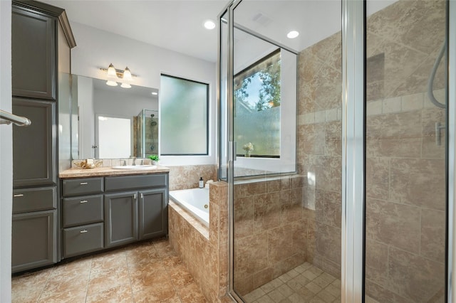 bathroom featuring shower with separate bathtub and vanity