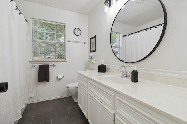 bathroom featuring tile patterned floors, toilet, and vanity