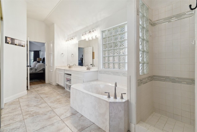 bathroom with a wealth of natural light, vanity, and independent shower and bath