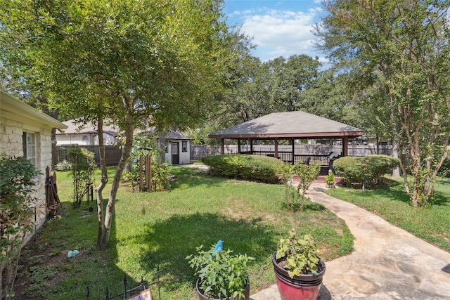 view of yard with a gazebo and a storage shed