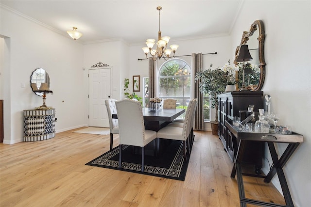 dining space featuring ornamental molding, hardwood / wood-style floors, and an inviting chandelier