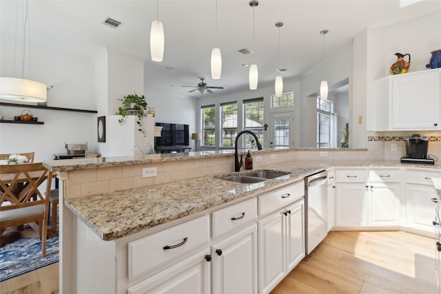 kitchen featuring light hardwood / wood-style floors, stainless steel dishwasher, hanging light fixtures, sink, and ceiling fan