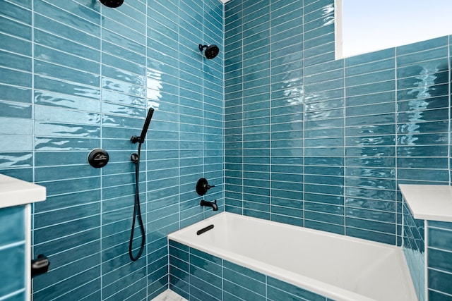 bathroom with tile walls and tiled shower / bath combo