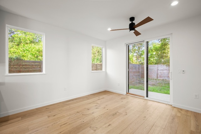 spare room featuring light wood-type flooring and ceiling fan