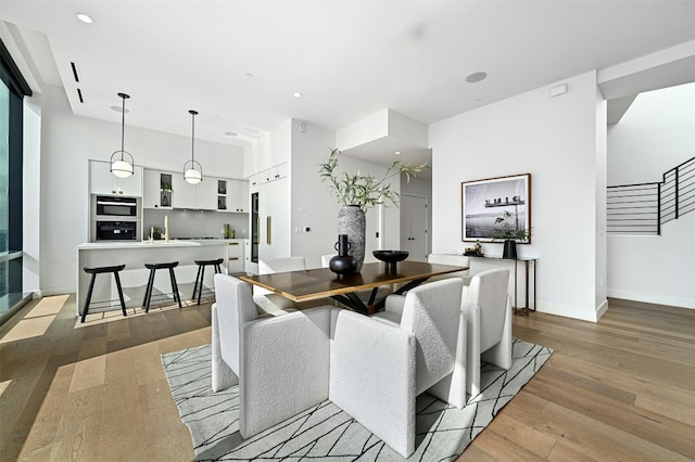 dining space with light hardwood / wood-style flooring