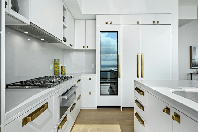 kitchen featuring white cabinets, light hardwood / wood-style floors, and stainless steel gas cooktop