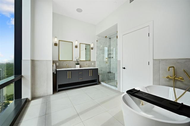 bathroom with tile patterned floors, vanity, and independent shower and bath