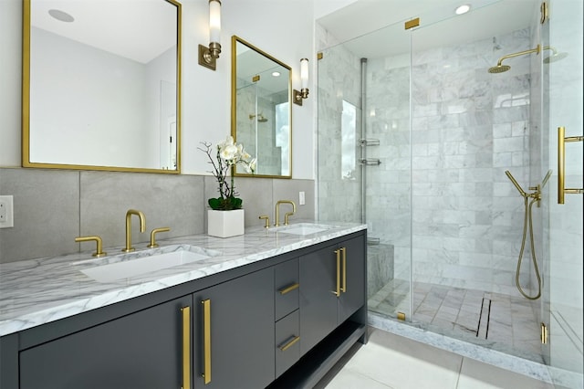 bathroom with tile patterned flooring, vanity, an enclosed shower, and tile walls