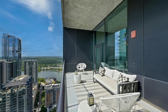 balcony featuring a water view and an outdoor hangout area