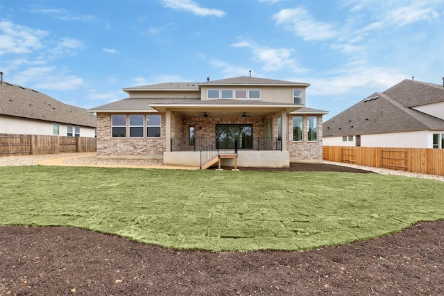 back of house featuring a patio, ceiling fan, and a lawn