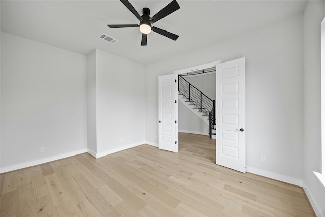 unfurnished room with ceiling fan and light wood-type flooring