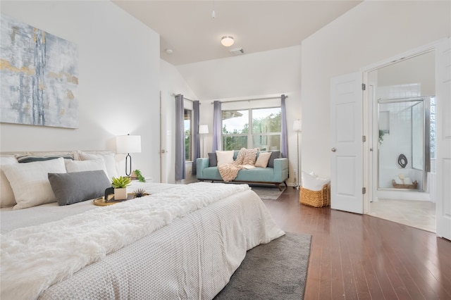 bedroom with dark hardwood / wood-style flooring and ensuite bath