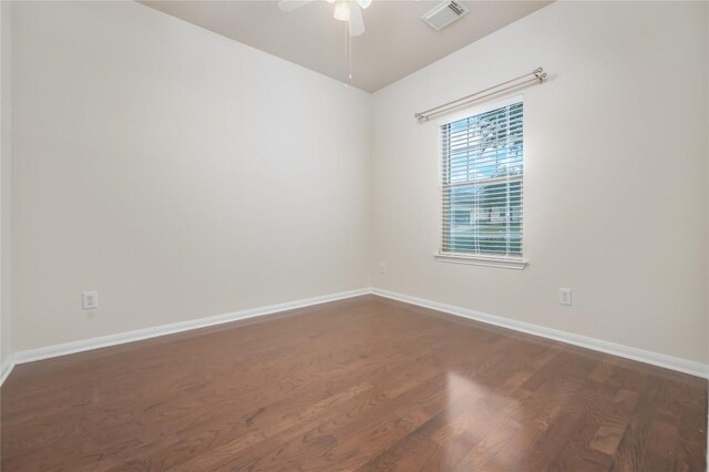 empty room featuring ceiling fan and dark wood-type flooring