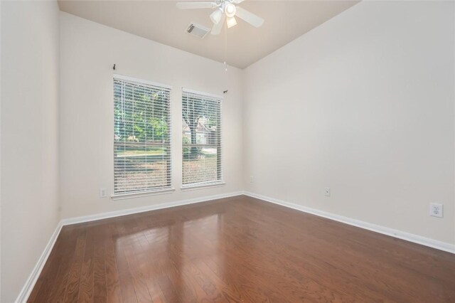 unfurnished room featuring ceiling fan and dark hardwood / wood-style flooring