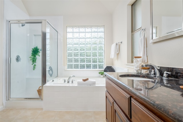 bathroom featuring tile patterned flooring, vanity, independent shower and bath, and vaulted ceiling