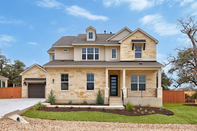 view of front facade featuring a garage and covered porch