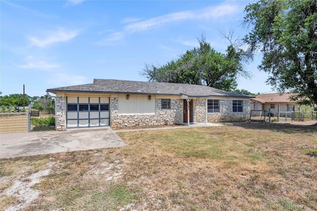 307 Golden Beach Dr, Buchanan Dam, TX 78609 - view of front of property featuring stone siding, driveway, a garage, and fence