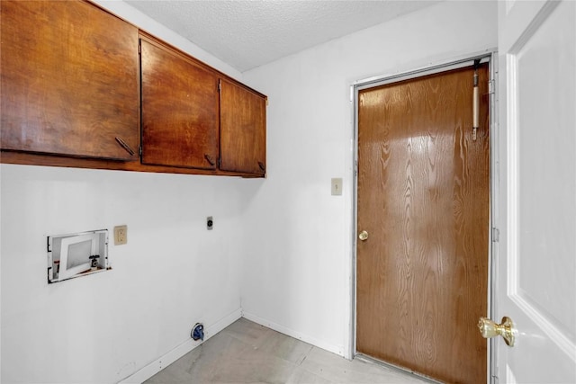 307 Golden Beach Dr, Buchanan Dam, TX 78609 - laundry room featuring baseboards, washer hookup, cabinet space, electric dryer hookup, and a textured ceiling