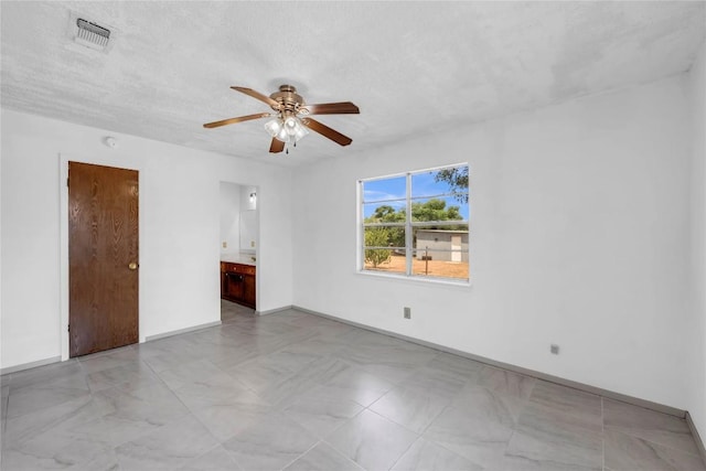 307 Golden Beach Dr, Buchanan Dam, TX 78609 - unfurnished room with baseboards, visible vents, a textured ceiling, and a ceiling fan