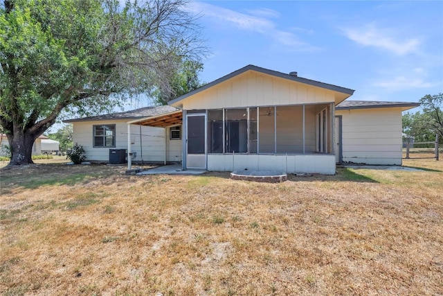307 Golden Beach Dr, Buchanan Dam, TX 78609 - rear view of house featuring central air condition unit, a lawn, and a sunroom