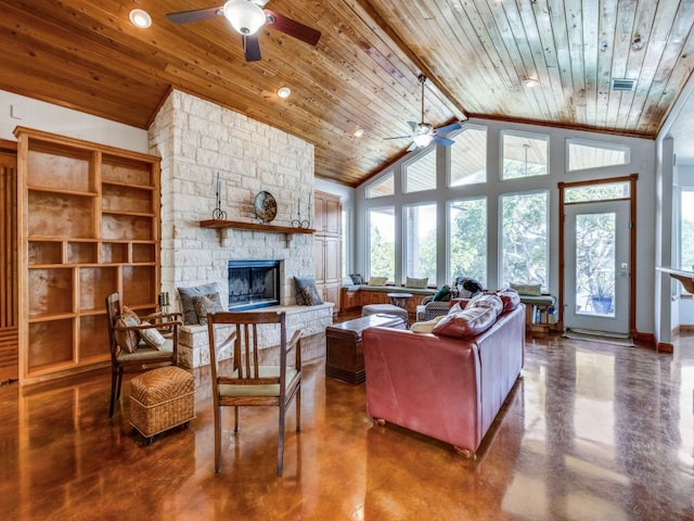 living room with ceiling fan, wooden ceiling, and a stone fireplace