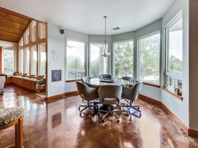 dining area with a textured ceiling and lofted ceiling