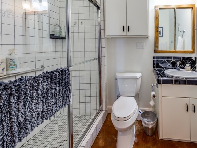 bathroom featuring vanity, toilet, backsplash, and a shower with shower door