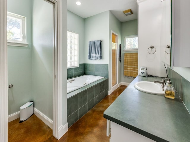 bathroom featuring vanity, a healthy amount of sunlight, concrete floors, and independent shower and bath