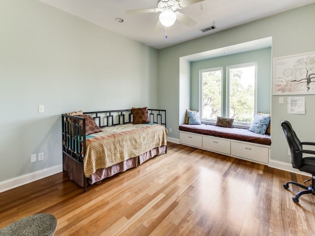 bedroom with light hardwood / wood-style flooring and ceiling fan