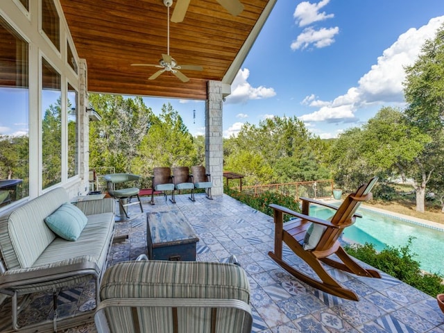 view of patio / terrace featuring ceiling fan, a fenced in pool, and outdoor lounge area