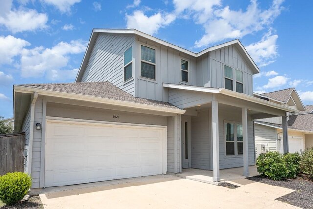 view of front facade featuring a garage and covered porch