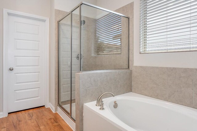 bathroom with plus walk in shower and wood-type flooring