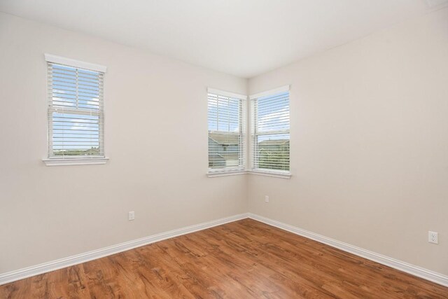 spare room with wood-type flooring